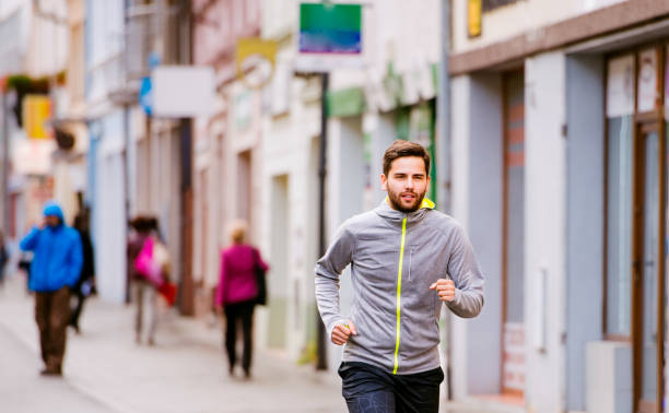 istock Young hipster man running in town, main street 538891550
