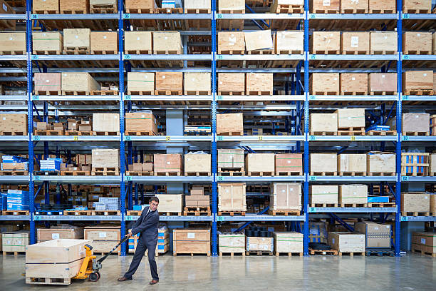 istock Manager carrying wooden box in warehouse. 538893286