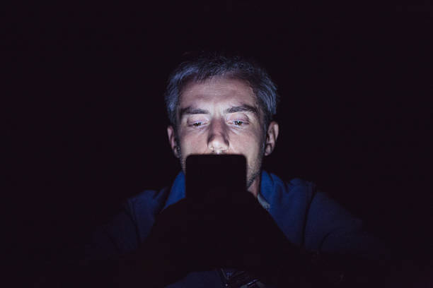 istock texting on a phone on a pitch black night outdoors 538893296