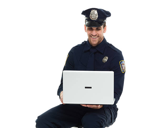 istock Cheerful police working on laptop 538893308