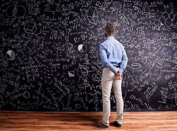 istock Hipster teacher against big blackboard with mathematical symbols 538893338