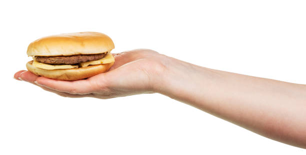 istock Tasty burger sandwich in hand isolated on white 538894686