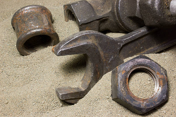 istock Old wrench and nuts on the sand 538895048