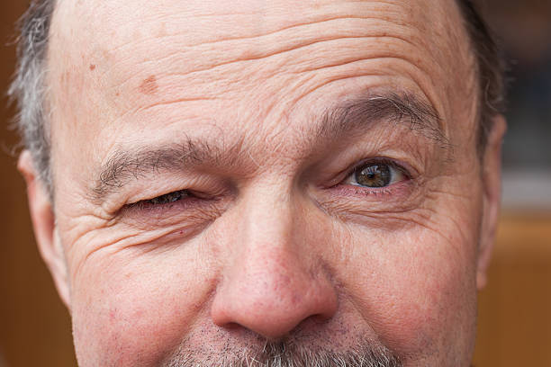 A close-up of the face of a man dressed as a cowboy or mountain man.