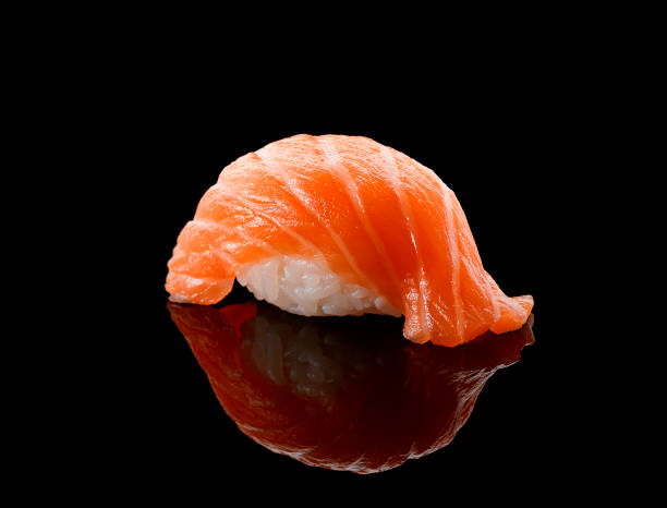 istock Salmon sushi nigiri over black background 538897516
