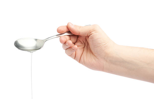 istock Male hand holding a spoon with oil 538898044