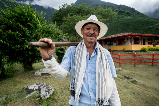 Latin American man working at a farm and looking very happy