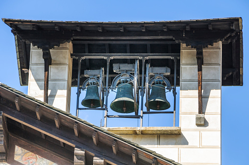 A trio of ancient bells in the bell tower of the Como Cathedral in Como, Italy