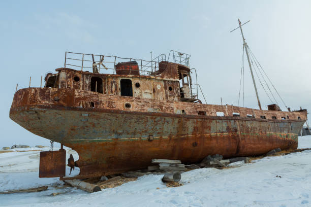 istock Old rusty ship on winter shore of Lake Baikal. 538902702
