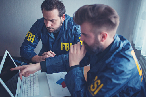 FBI agents working in the office on a crime case.