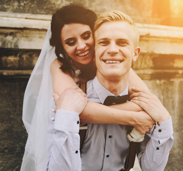istock groom carries bride on his back 538903774