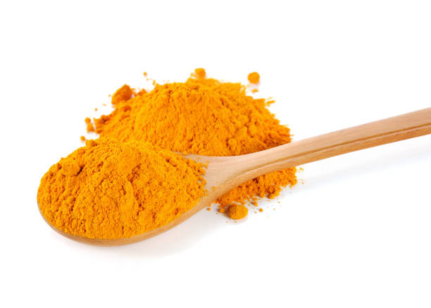 istock Turmeric (Curcuma) powder on wooden spoon isolated on white back 538903928