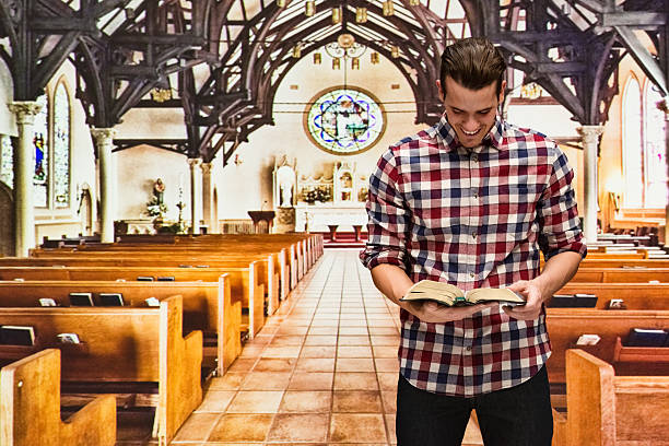 istock Man reading bible in church 538905186