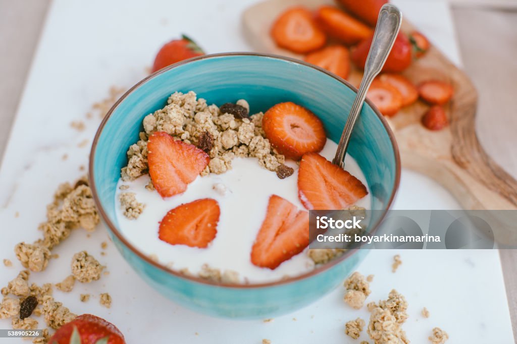 Fresh strawberries , yogurt and homemade granola for healthy breakfast Backgrounds Stock Photo