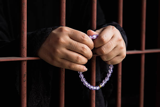 istock Muslim woman hand in jail 538906982