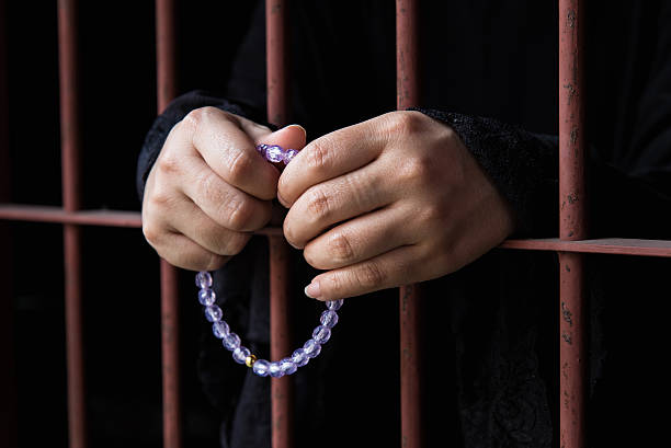 istock Muslim woman hand in jail 538907068