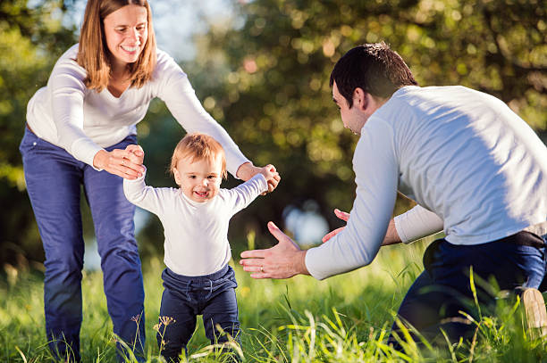 istock Parents holding their little son making first steps 538907118