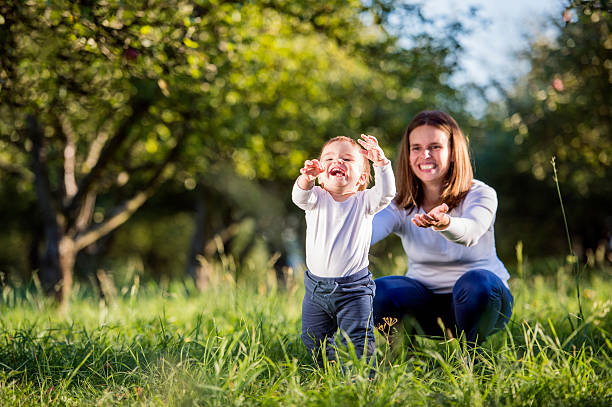 istock Mother with her son making first steps, green nature 538908518