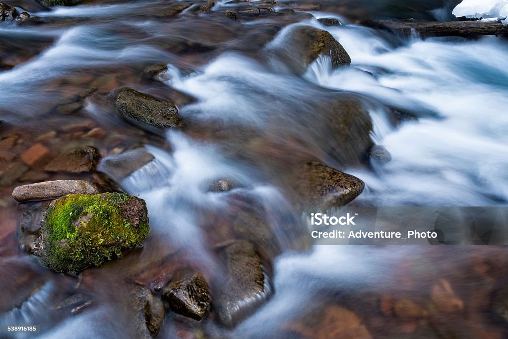 Flowing Stream of Water Flowing Stream of Water - Scenic landscape with mountain water cascading down. 2015 Stock Photo