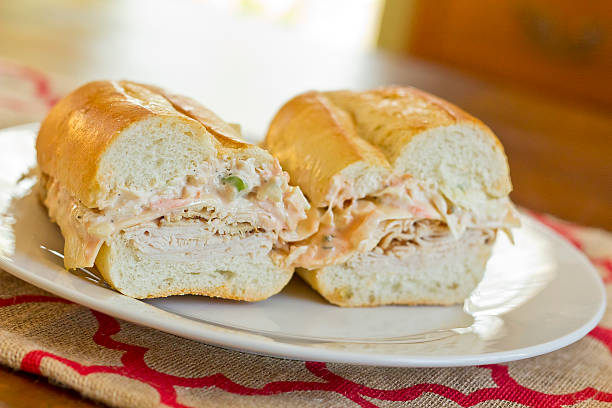 Turkey Reuben Healthy alternative, turkey reuben on a torpedo roll with cole slaw dressing torpedo sandwich stock pictures, royalty-free photos & images