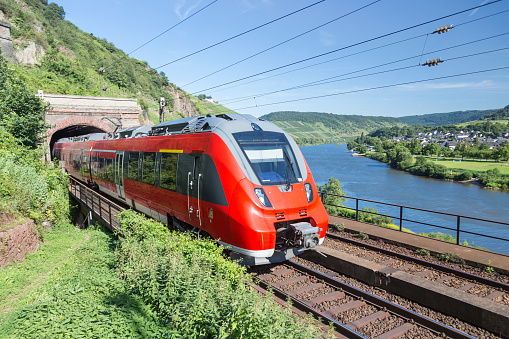 Intercity train leaving a tunnel near the river Moselle in Germany