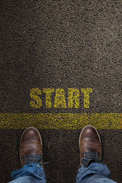 istock pair of feet on a tarmac road 538919327