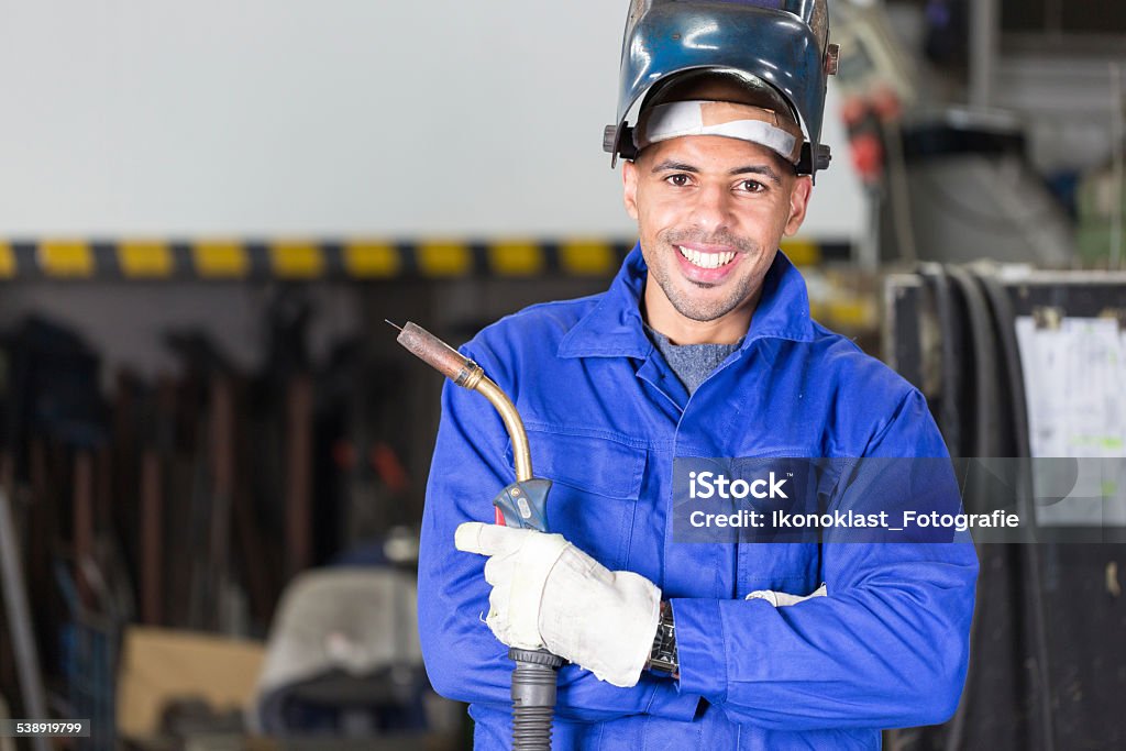 Professional welder posing with wellding machine Professional welder posing with wellding machine and torch Welder Stock Photo