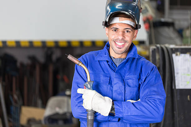 Professional welder posing with wellding machine Professional welder posing with wellding machine and torch welding torch stock pictures, royalty-free photos & images
