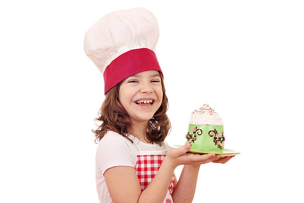 istock happy little girl cook with cupcakes 538927701