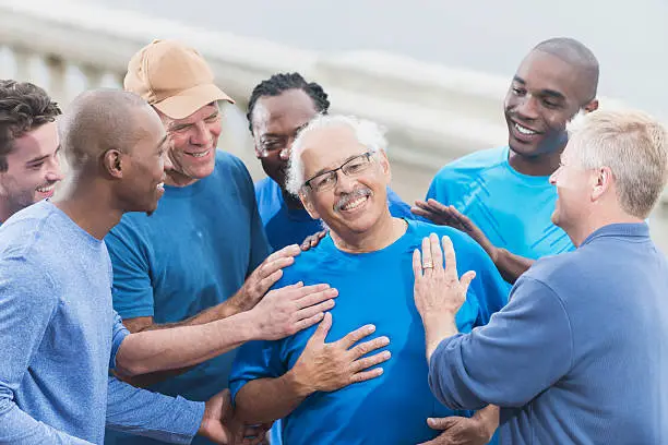 Photo of Proud senior Hispanic man with group of friends