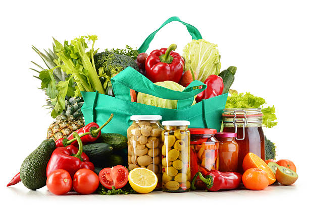 istock Green shopping bag with groceries isolated on white 538928305