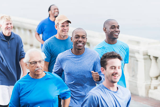 istock Multiracial group of men in blue shirts running 538928737