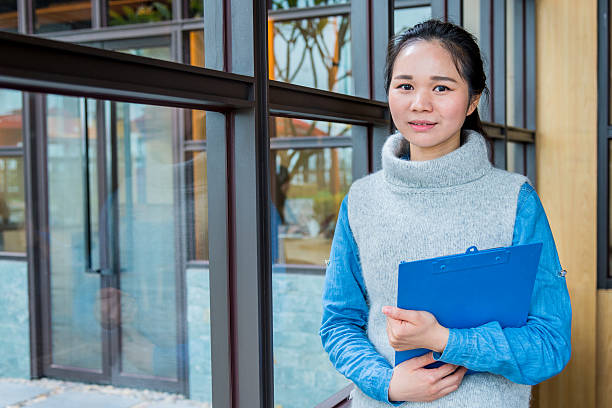 istock business woman holding clipboard 538928815