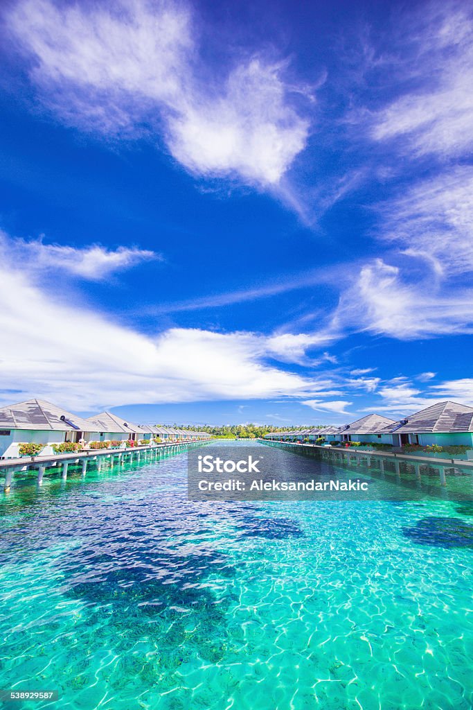 Turquise water of Maldivien islands Photo of a tropical island of Maldives and its bungalows on the water 2015 Stock Photo