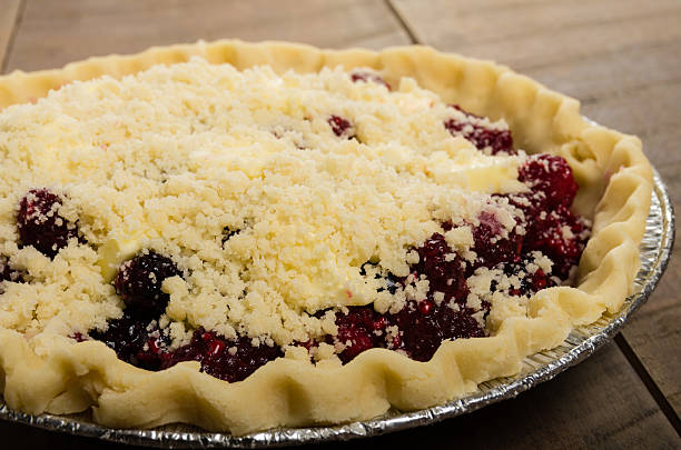Baking homemade fresh fruit pies Homemade fresh fruit pies on a tray made with raspberries marionberry stock pictures, royalty-free photos & images