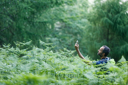 Hiker searching way to cache using global positioning device