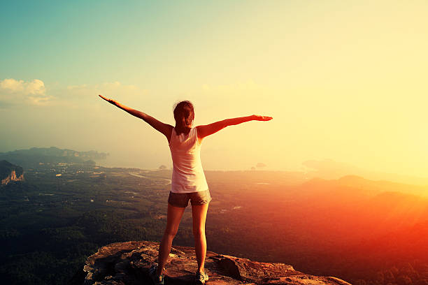 istock cheering hiking woman on mountain peak 538931951