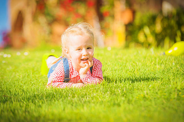 istock Marvelous little girl plays with on green spring grass 538951839