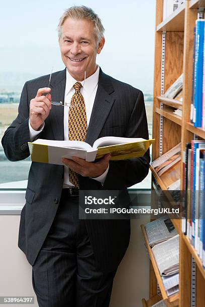 Business Person In Library Stock Photo - Download Image Now - 2015, 55-59 Years, Active Seniors