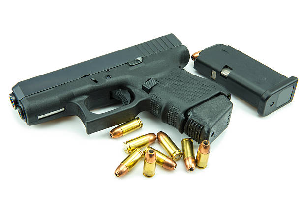 istock Black gun and 9mm bullets isolated a white background. 538965589