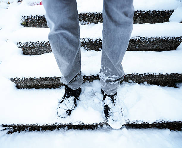 istock Man in snow covered stairs 538965695