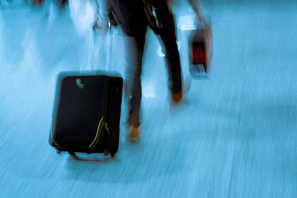 These long exposure Images of suitcases and travelers depict the frenetic pace often felt at airports worldwide. They have motion blur, copy space and room for cropping. - not released