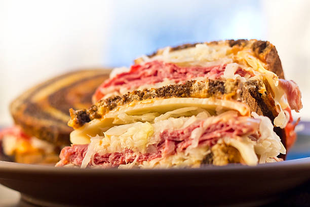 Reuben Chips Pickle Famous New York Reuben corned beef sanwich with chips and a pickle reuben sandwich stock pictures, royalty-free photos & images