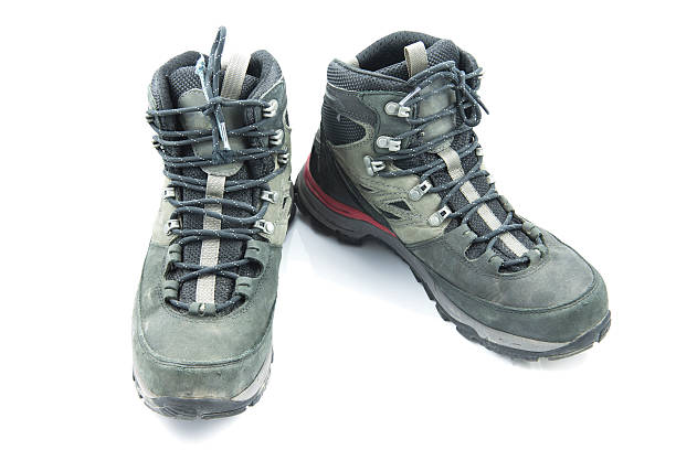 istock Pair of dirty grey hiking boots isolated on white background. 538979725