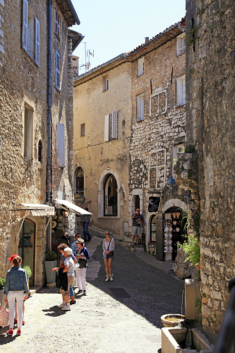 Saint Paul de Vence, France - May 12, 2013: Beautiful narrow street with old houses in Saint Paul de Vence, one of the oldest towns of the Provence, France, famous town of painters and galleries.