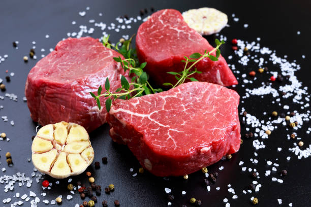 istock Fresh Raw Beef steak Mignon, with salt, peppercorns, thyme, garlic. 538980792