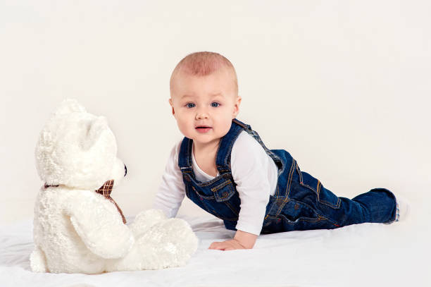 istock the little boy plays with a teddy bear 538981118