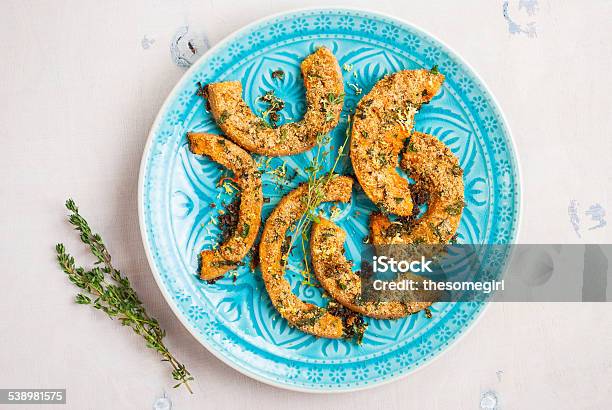 Roasted Pumpkin Slices With Herbs On White Wooden Table Stock Photo - Download Image Now