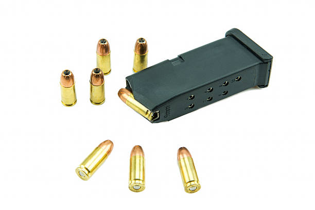 istock 9mm bullets and magazine isolated on white background. 538982725