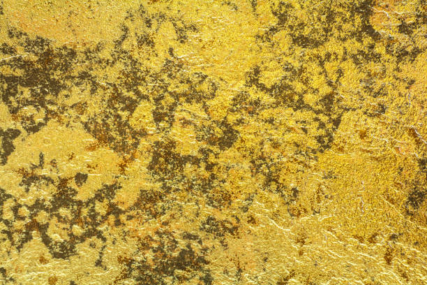 istock Abstract background texture of stone wall in yellow gold tone. 538983106